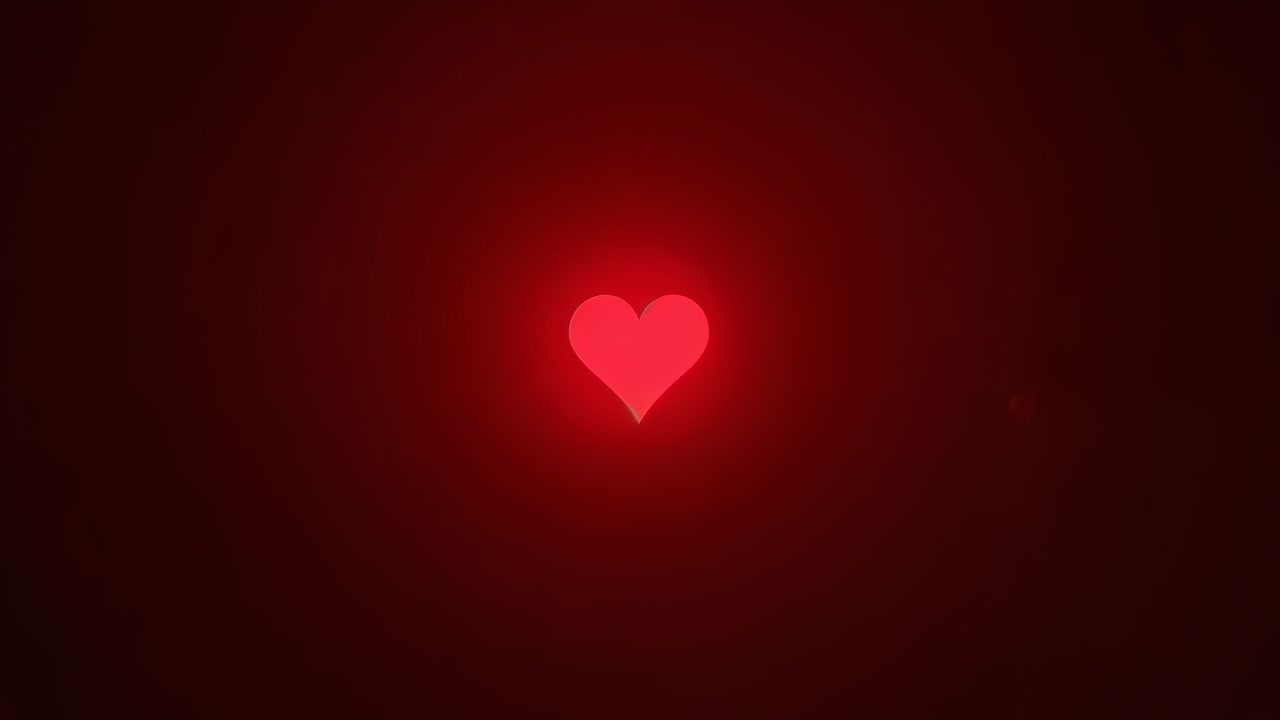 All'inizio della riproduzione, cuore rosso pulsante, alone che si illumina e si espande su gradiente radiale scuro