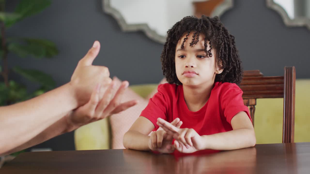 Happy biracial man and his son using sign language