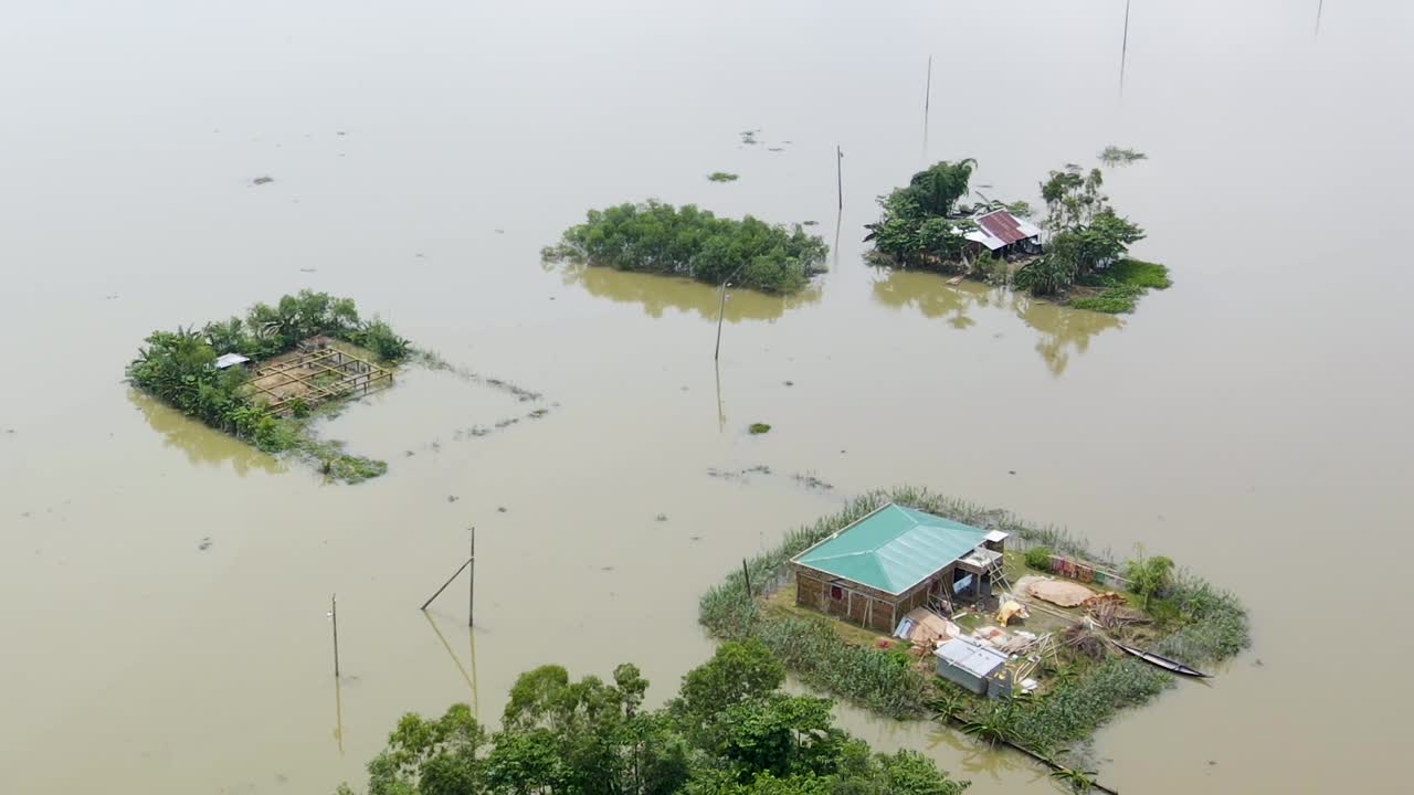 Rural village homes submerged in flood water in Bangladesh. Aerial drone shot