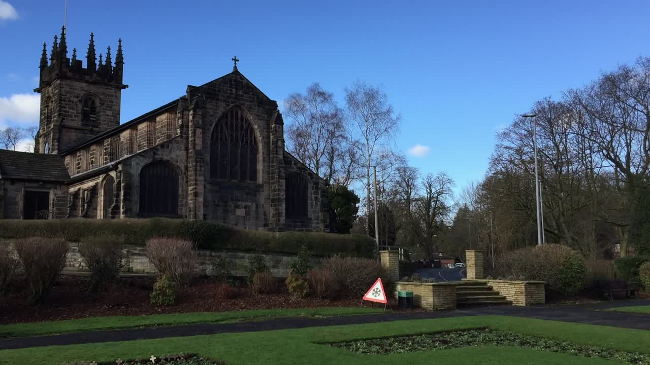 Bright winter view of St Bartholomew's Church in the town of Wilmslow, Cheshire, England, from the Memorial Garden. The church is recorded as a designated Grade I listed building.