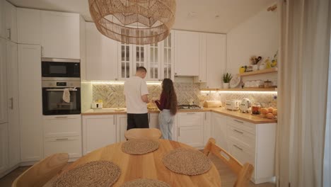 loving couple making a sandwich in kitchen-living room