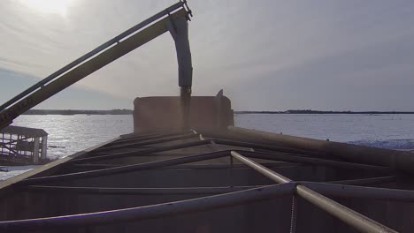 loading a semi truck with grain on a winter day