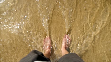 male-tourist-walking-into-the-brown-lake,-north-stradbroke-island,-Queensland,-Australia