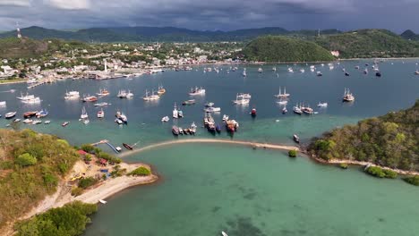 aerial view of a harbor with many boats and a city in the background