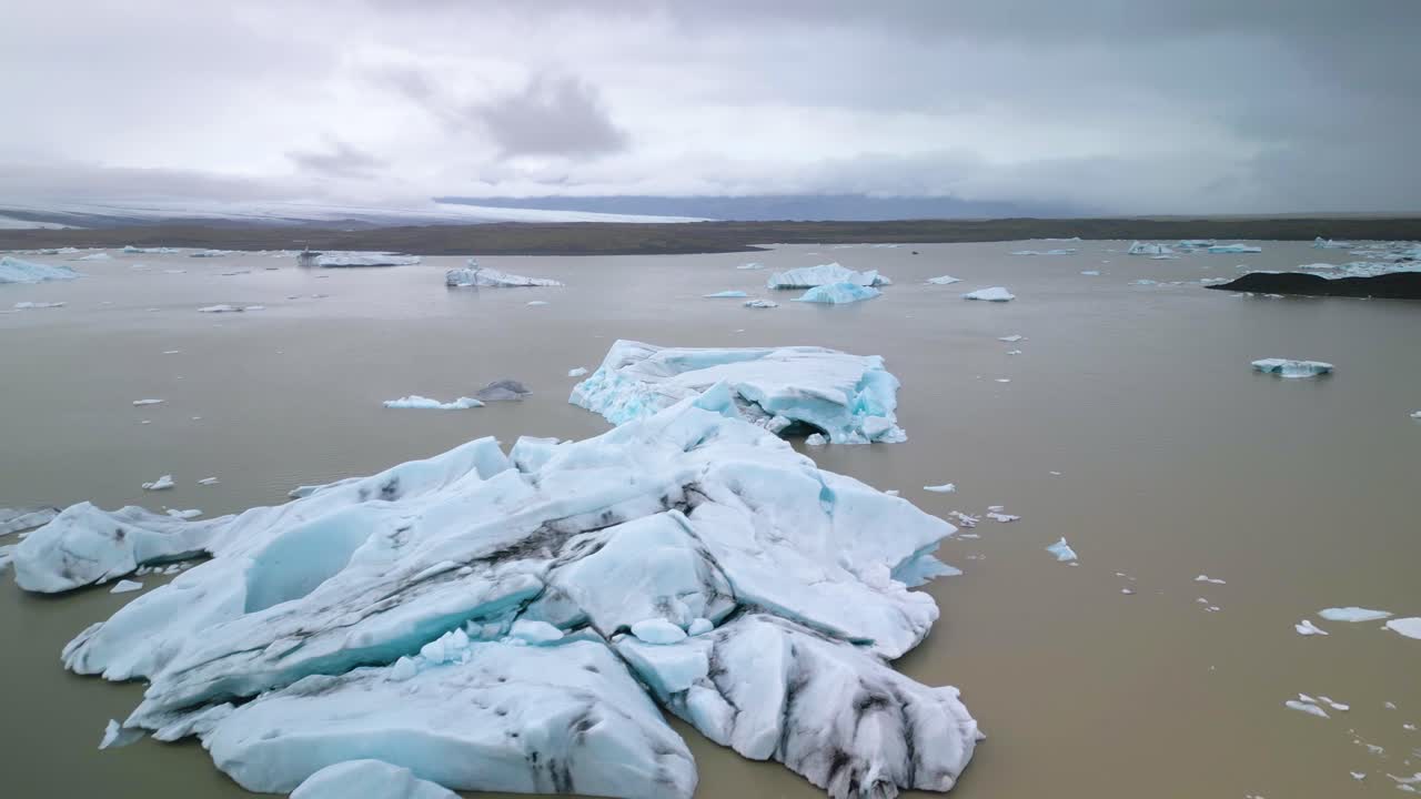 Cinematic Establishing Shot of Large Icebergs in Glacial Lake