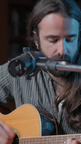 musician singing and playing acoustic guitar
