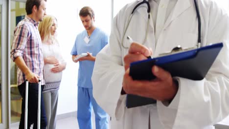 Portrait-of-male-doctor-holding-a-medical-report