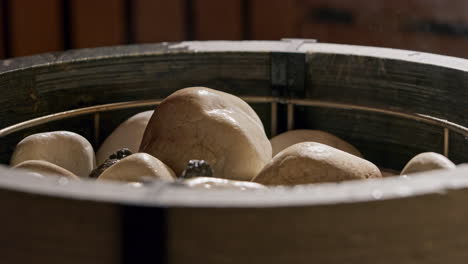 throwing water on the sauna stones in the sauna stove, creating steam to heat the steam room