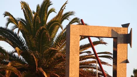 oeiras beach arch, adorned with swaying palm trees, basks in the gentle morning breeze of the golden hour, creating a serene and captivating scene