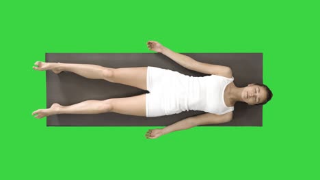 yoga meditation laying on a mat with closed eyes on a green screen, chroma key