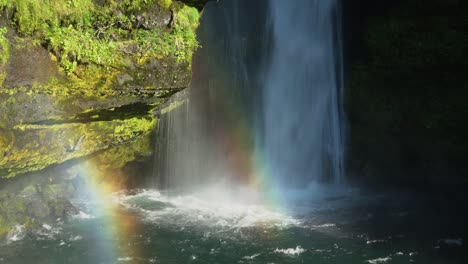 spectacular icelandic gluggafoss waterfall and colorful rainbow reflecting in sunlight - medium shot