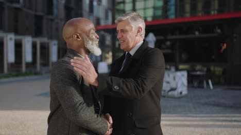 portrait-of-professional-executive-businessmen-meeting-shaking-hands-smiling-happy-in-city