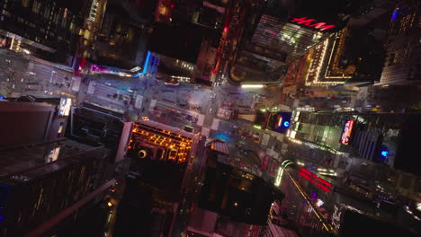 Aerial-birds-eye-overhead-top-down-footage-of-Times-Square-at-night.-Highly-illuminated-place-between-tall-buildings-in-midtown.-Manhattan,-New-York-City,-USA