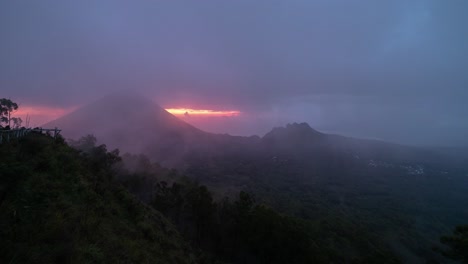 dramatic volcanic landscape with misty sunrise or sunset