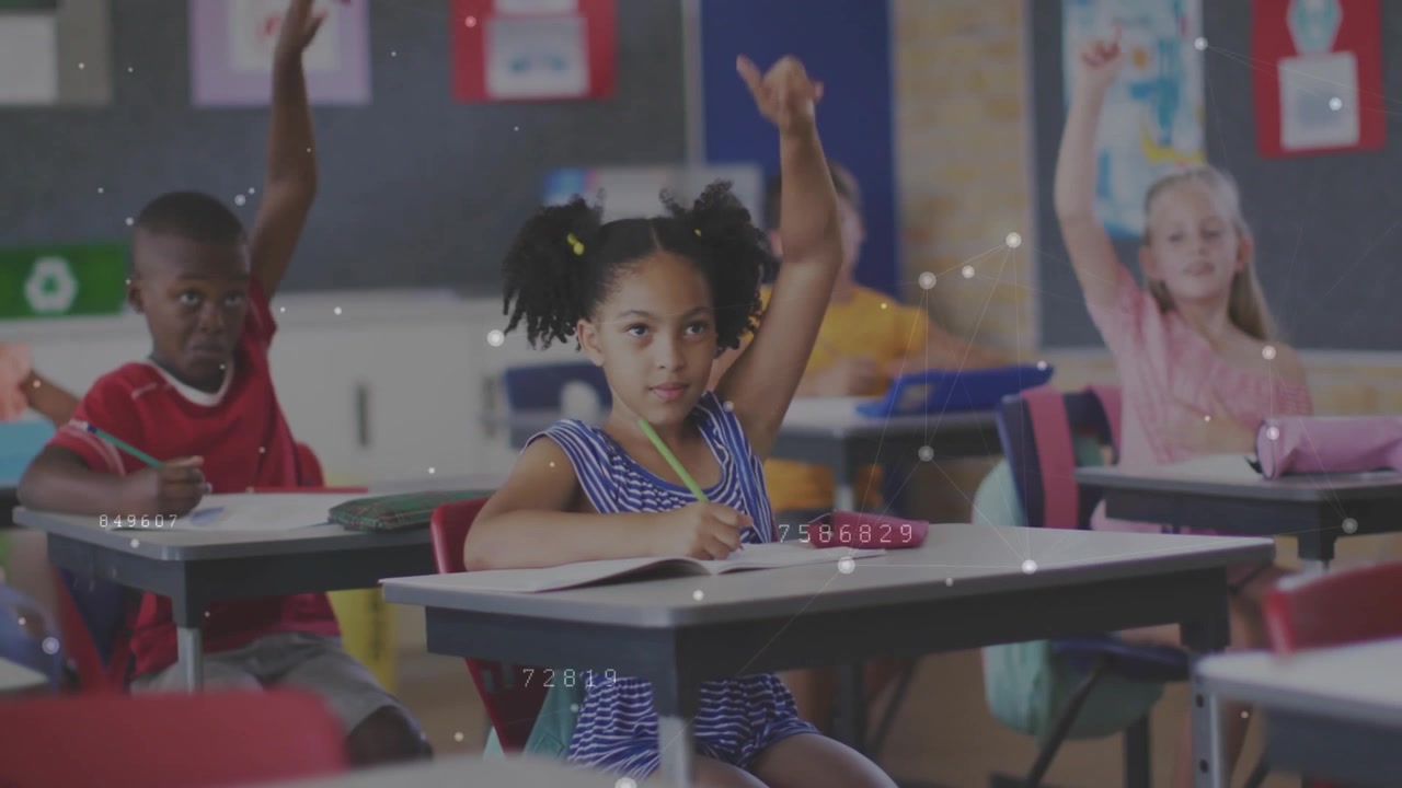 Elementary students writing with data overlays then raising hands after teacher asking question