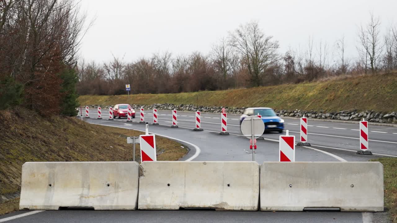 Road blocked with concrete barriers and traffic signs