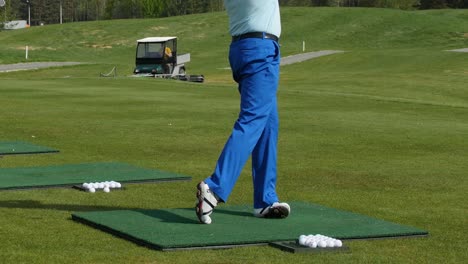 man practicing golf swing on a golf course