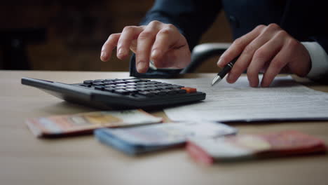 man hands counting calculator sitting table close up. accountant calculating.