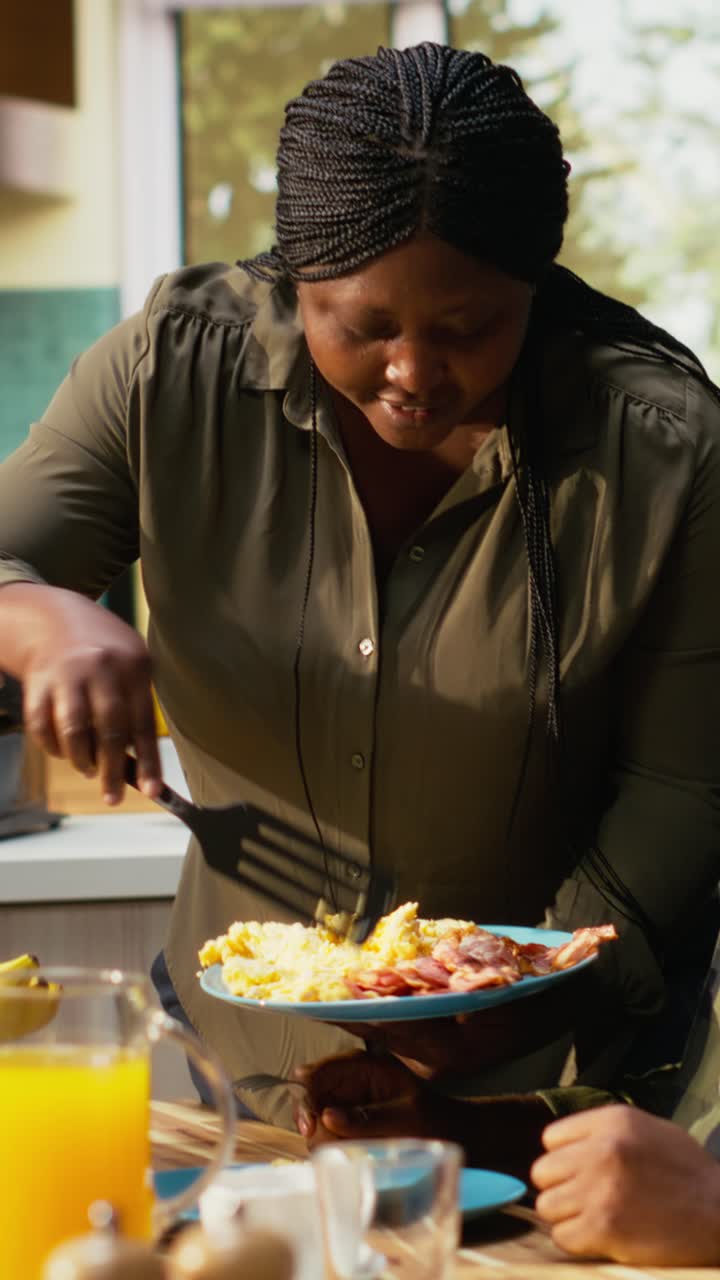 Vertical Video Happy black family enjoying breakfast together in kitchen with delicious food
