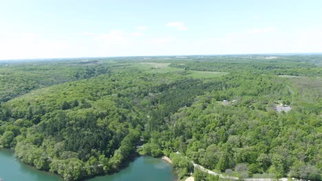 Horizontal-shot-of-a-dense-forest-landscape-in-the-evergreen-mountains-of-Wisconsin,-USA,-during-this-hot-summer-afternoon