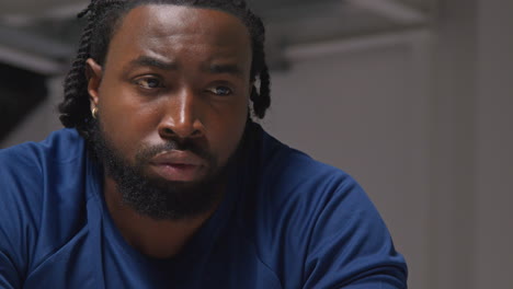 close up portrait of determined male athlete sport training in gym sitting and concentrating in changing room with focused expression 5