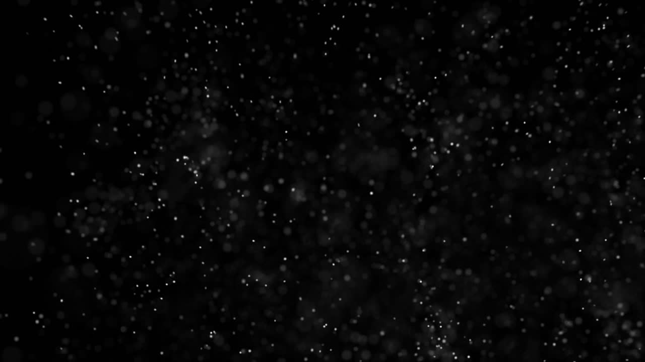 Gentle snowfall with bokeh depth on black background. Dreamy winter overlay for Christmas videos. Seamless loop