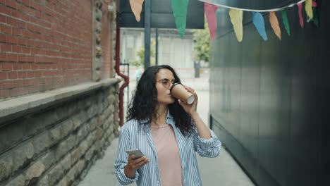 young woman enjoying coffee in an urban alley