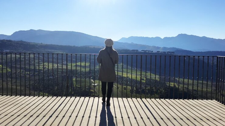 Tracking shot of a tourist taking photos of the beautiful scenery at Ronda, Spain