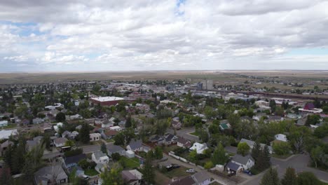 drone view of suburban landscape and distant mountains in montana