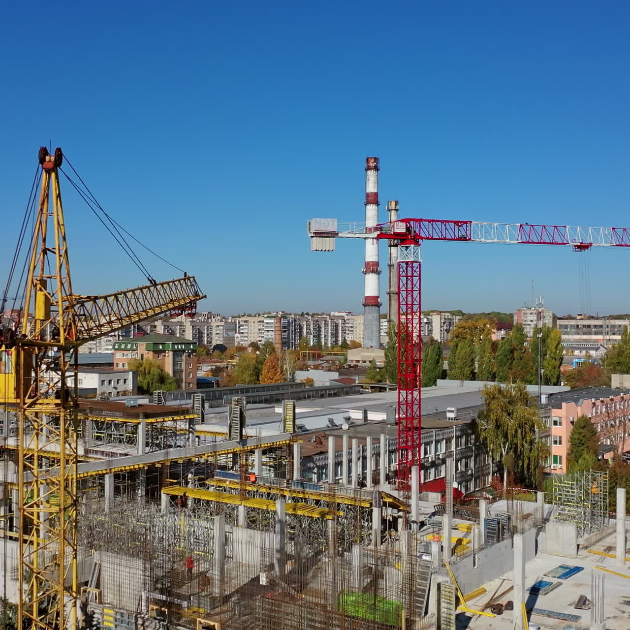 Construction site with a bird's eye in a megacity. Video shooting with drone. New office in a new residential complex. Aerial view.