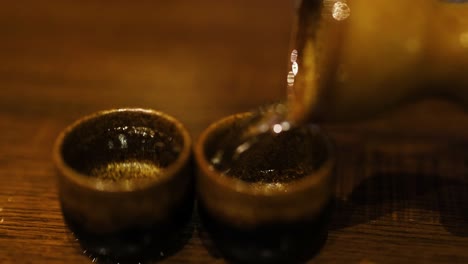 sake being poured into two cups