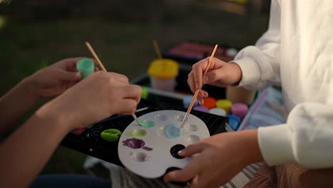 mother and child painting outdoors