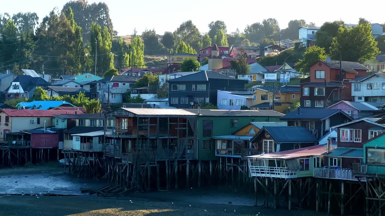 Panoramic shot of Colorful wooden stilt houses in Gamboa at low tide, Castro