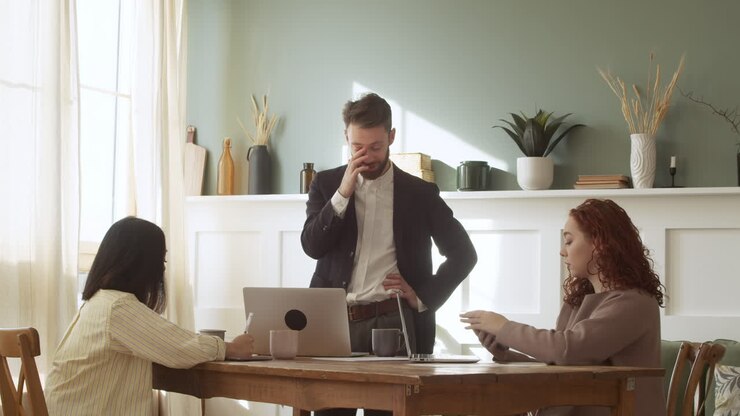 hombre de negocios debatiendo con dos colegas durante una reunión de equipo 1