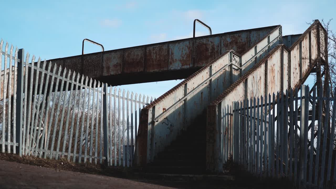 An old rusty pedestrian railway bridge