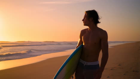 surfer on a beach at sunset