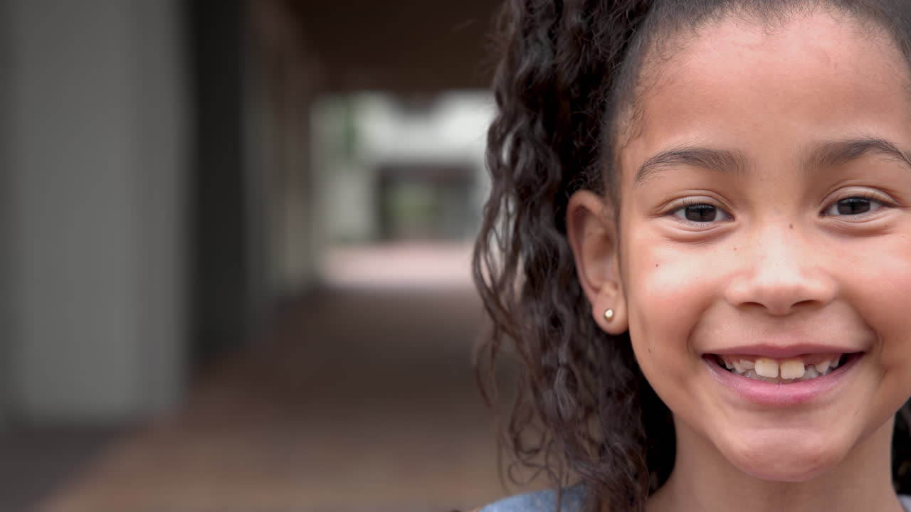 Smiling girl outdoors, showing joy and happiness in school environment, copy space