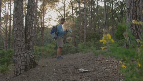 male hiker walking in forest