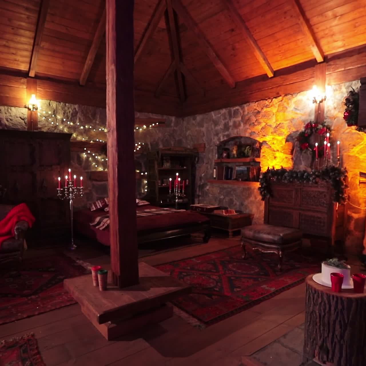 Cozy stone house with wooden roof and beams. Beautiful room with old furniture decorated for Christmas celebrations