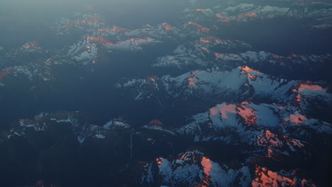 a beautiful sunset from an airplane view of mountains