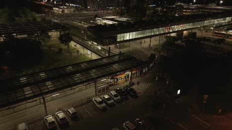 aerial view of a modern electric streetcar entering depot transport interchange late evening, poland, warsaw