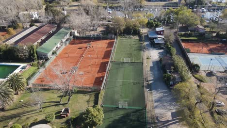aerial over sports complex showing tennis court and football ground
