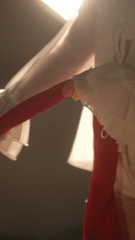 woman tying a red cloth