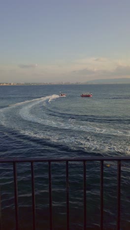speedboat turning in the mediterranean sea near acre old city, israel