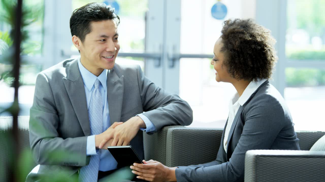 Multi ethnic male female business team using tablet