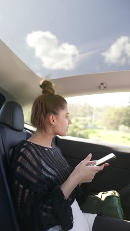 Woman using phone in a car