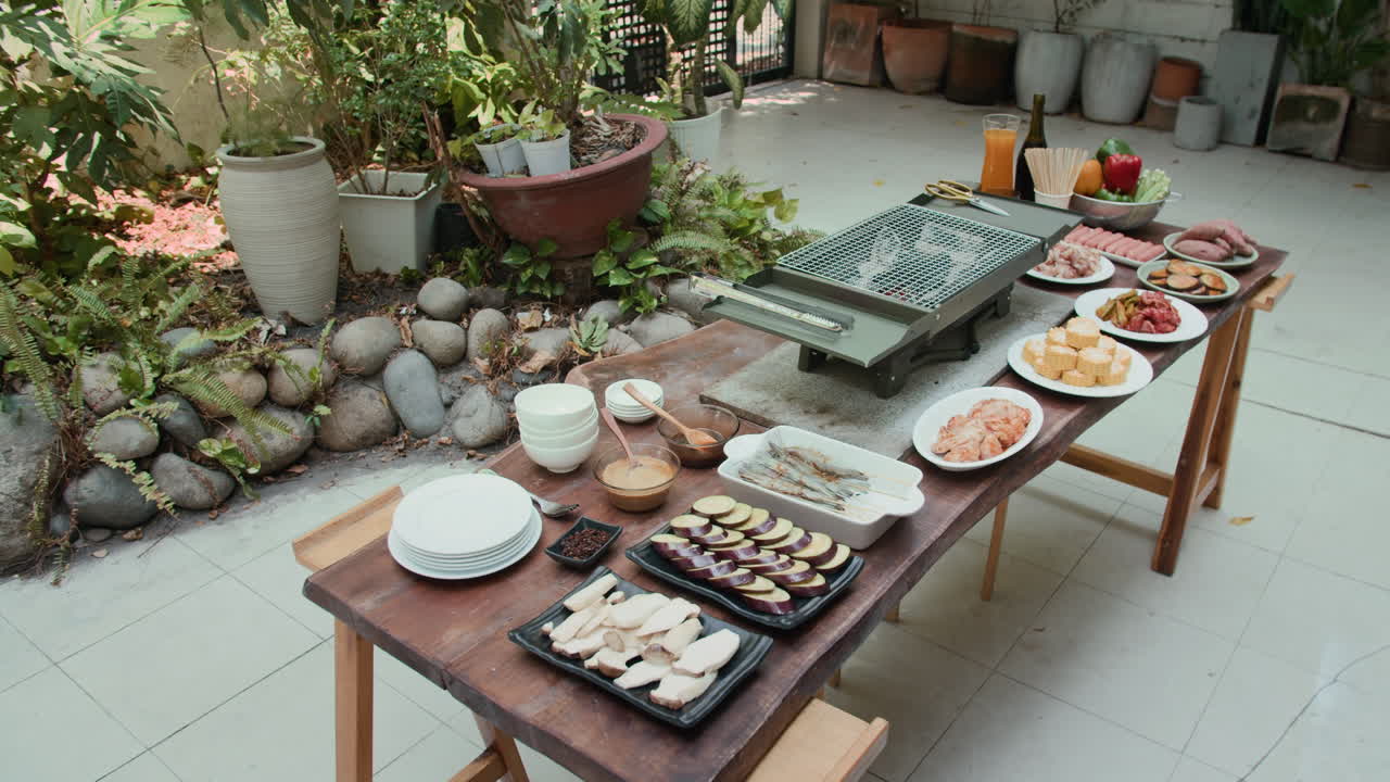 Vegetables and Meat for Barbecue on Table in Backyard