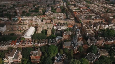 aerial shot of amsterdam with houses and volden church