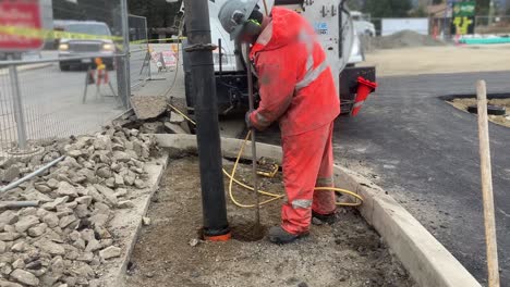 hydrovac truck and construction workter expertly expose underground utility lines