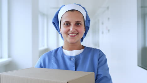 female worker portrait smiling. worker woman looking at camera